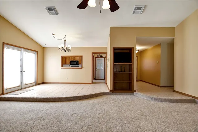 an empty room with a empty space and windows