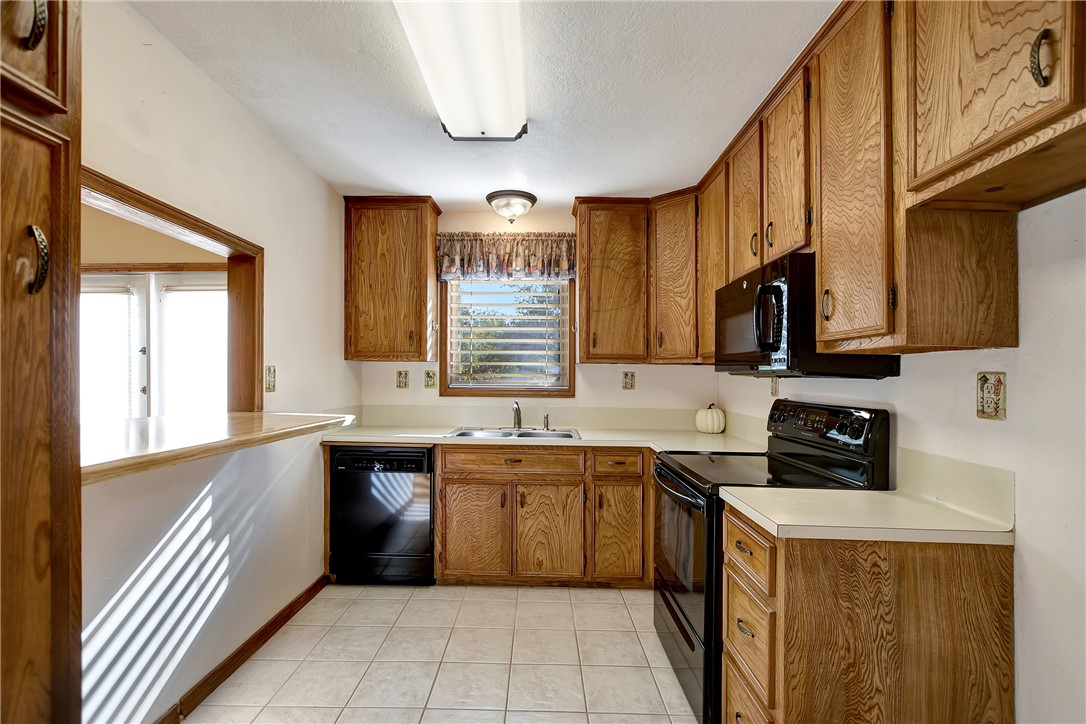 8846 Jackrabbit Lane Bryan, TX 77808 - Photo 21 of 48 a kitchen with stainless steel appliances a sink stove and cabinets