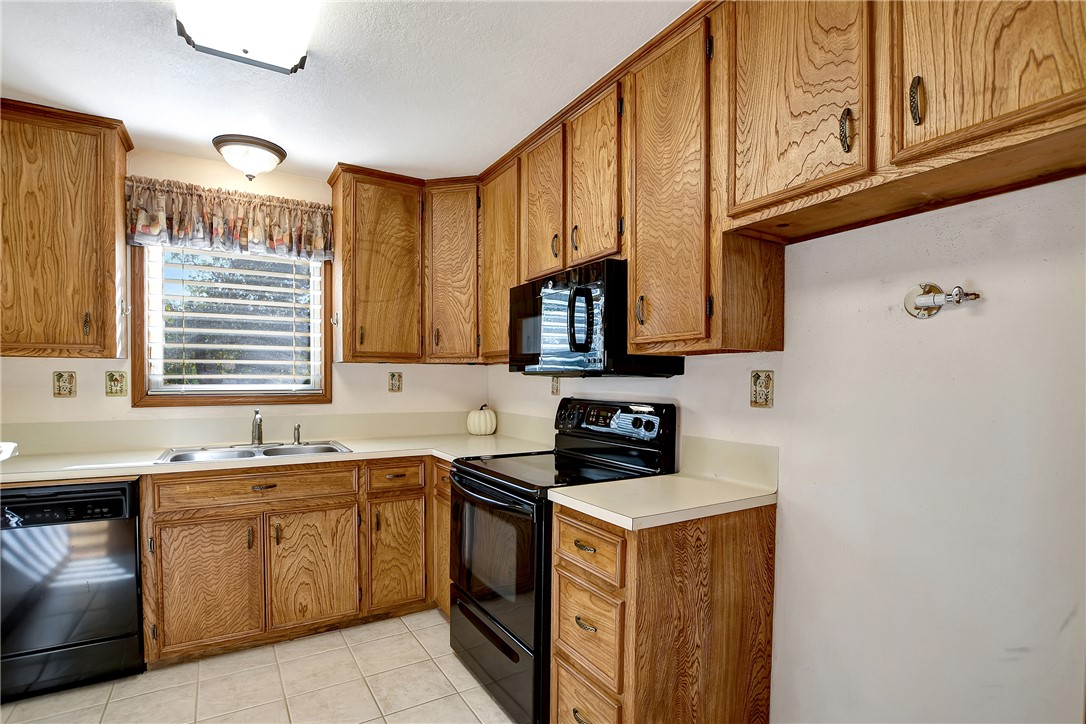 8846 Jackrabbit Lane Bryan, TX 77808 - Photo 22 of 48 a kitchen with stainless steel appliances granite countertop a sink stove and cabinets