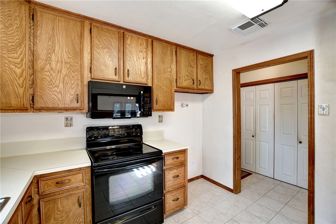 8846 Jackrabbit Lane Bryan, TX 77808 - Photo 25 of 48 a kitchen with stainless steel appliances granite countertop a stove and a microwave
