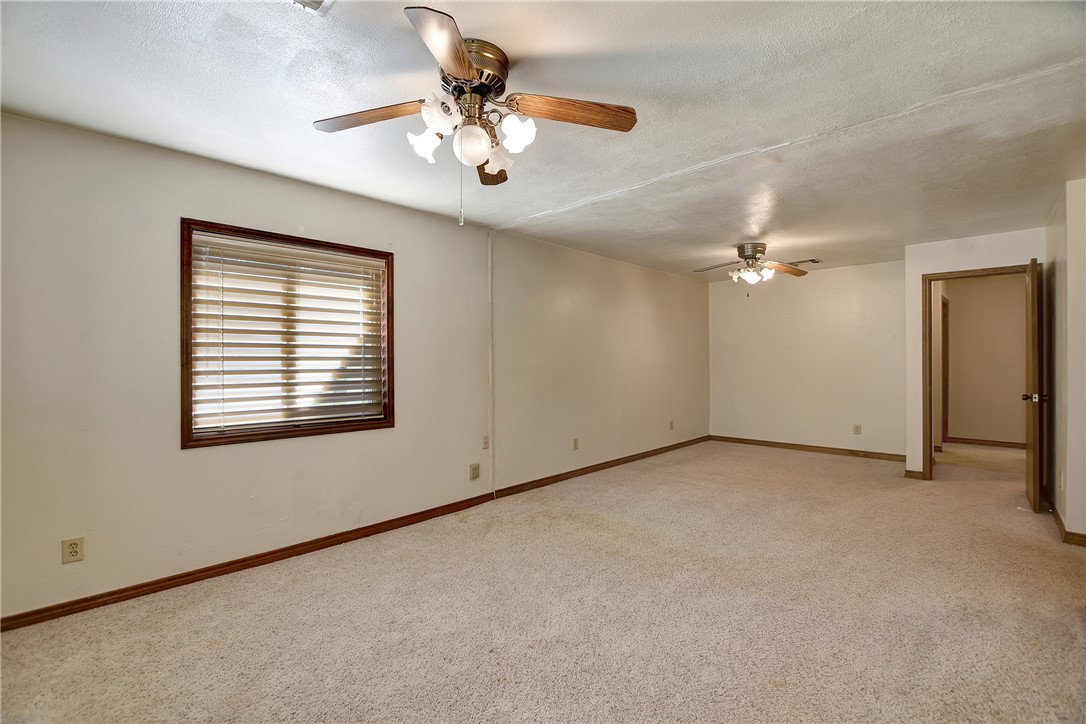 8846 Jackrabbit Lane Bryan, TX 77808 - Photo 27 of 48 an empty room with a chandelier fan and windows