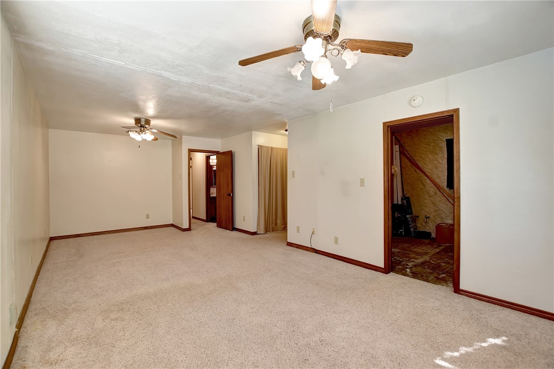 8846 Jackrabbit Lane Bryan, TX 77808 - Photo 28 of 48 an empty room with chandelier fan and closet