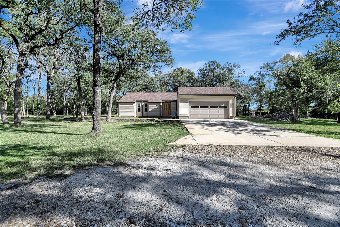 8846 Jackrabbit Lane Bryan, TX 77808 - Photo 3 of 48 a view of house with outdoor space and trees
