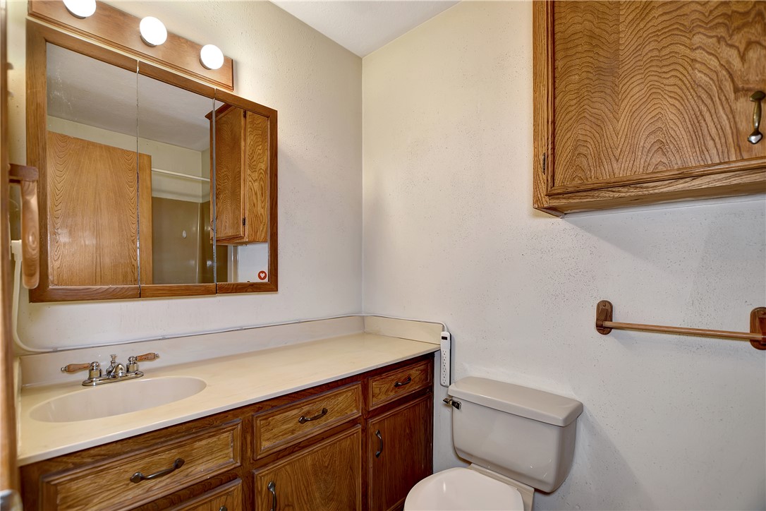 8846 Jackrabbit Lane Bryan, TX 77808 - Photo 31 of 48 a bathroom with a toilet sink and mirror