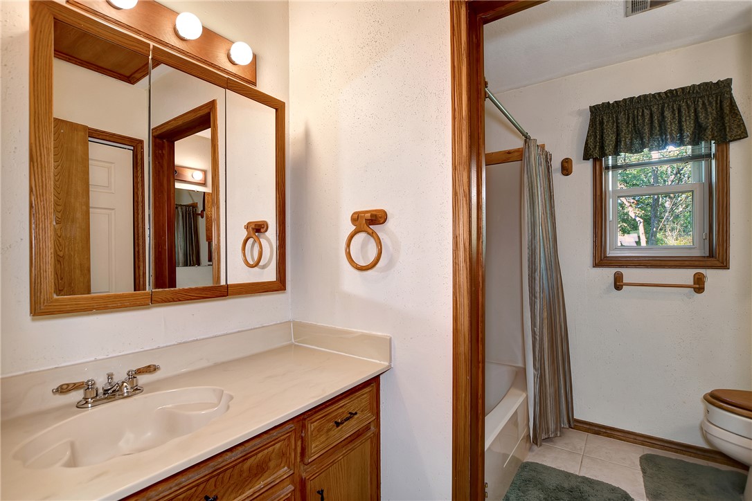 8846 Jackrabbit Lane Bryan, TX 77808 - Photo 35 of 48 a bathroom with a sink a mirror and a window
