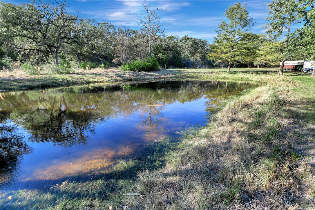 8846 Jackrabbit Lane Bryan, TX 77808 - Photo 48 of 48 a view of a lake with a yard and trees