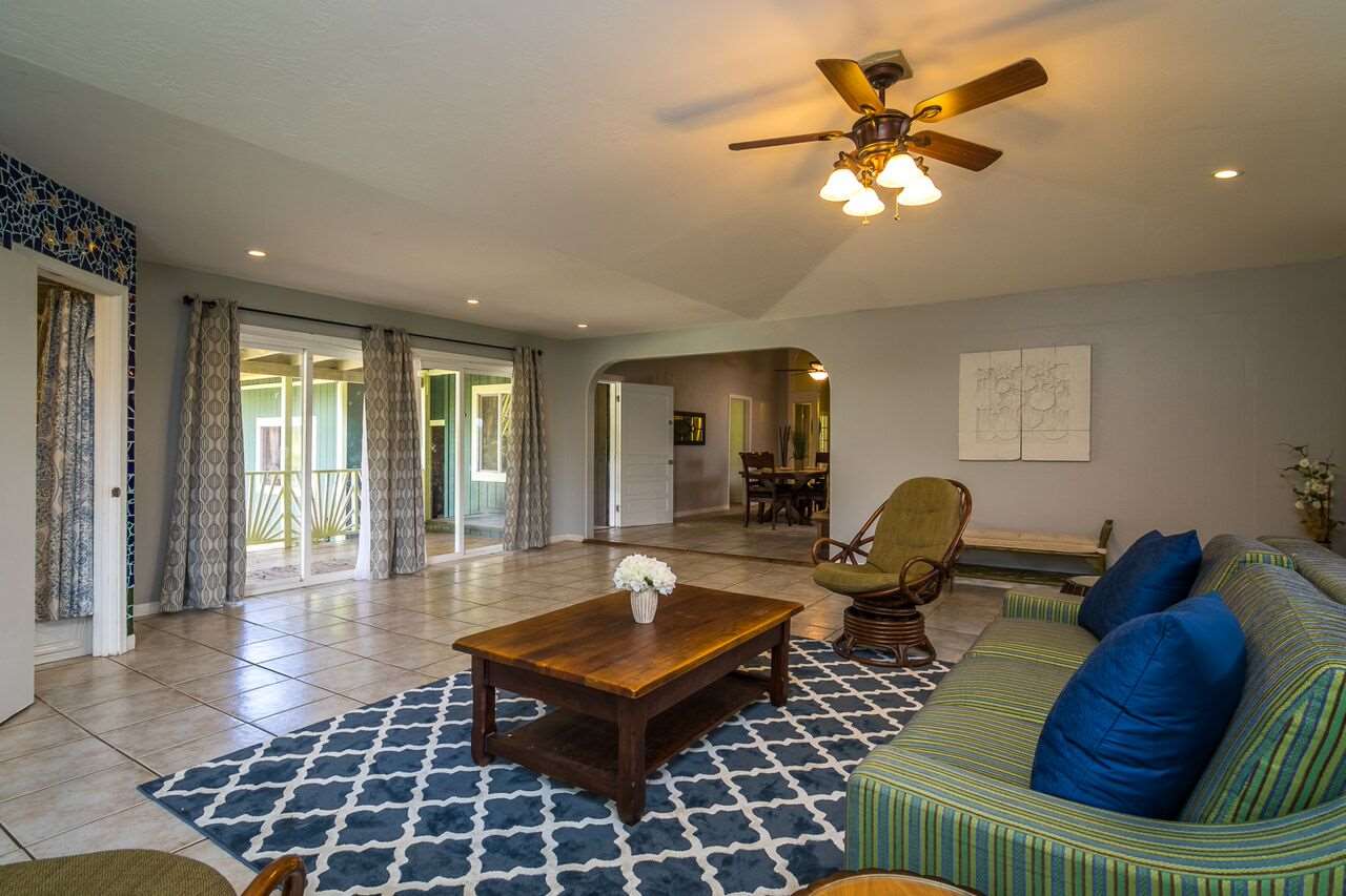 34 Door Of Faith Road Haiku, HI 96708 - Photo 2 of 8 a living room with furniture a rug and a chandelier