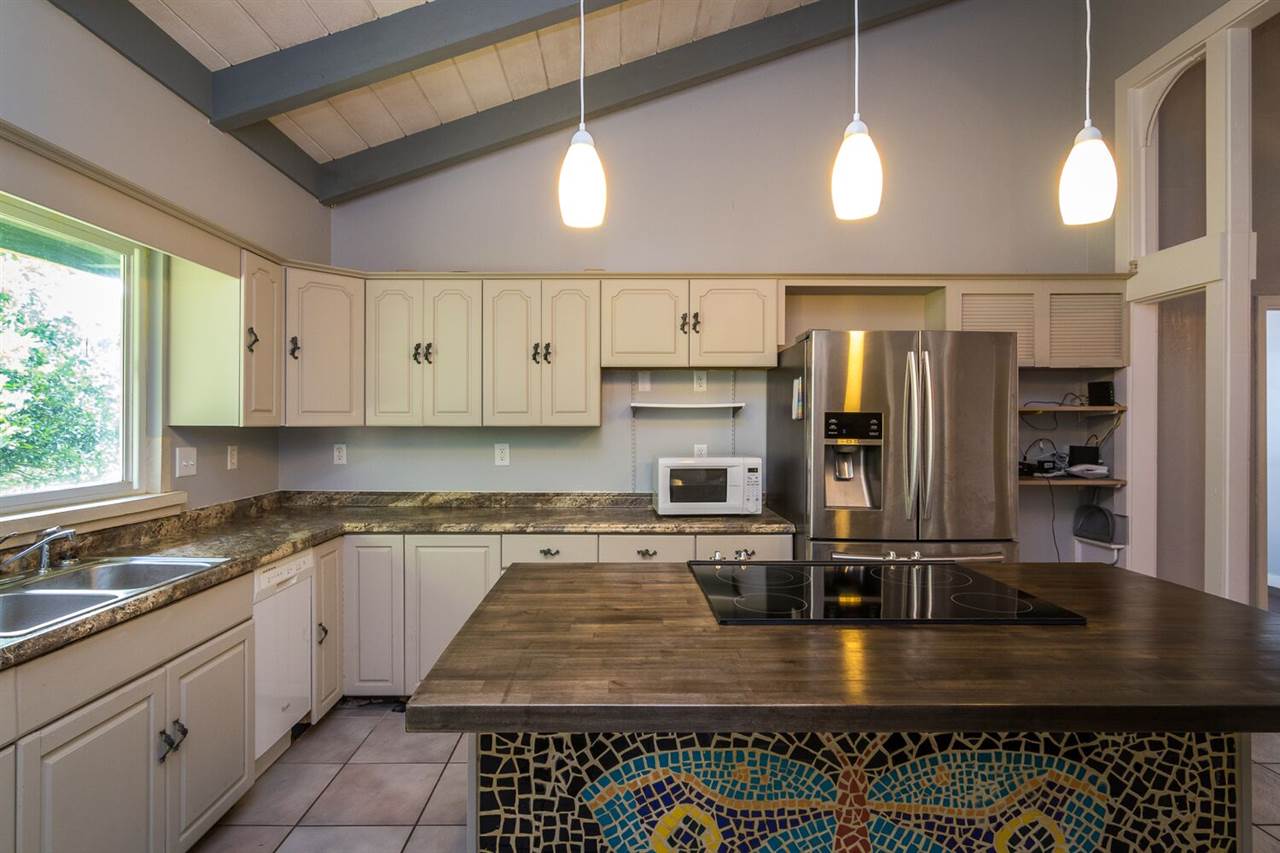 34 Door Of Faith Road Haiku, HI 96708 - Photo 4 of 8 a kitchen with stainless steel appliances granite countertop a stove a sink and a refrigerator