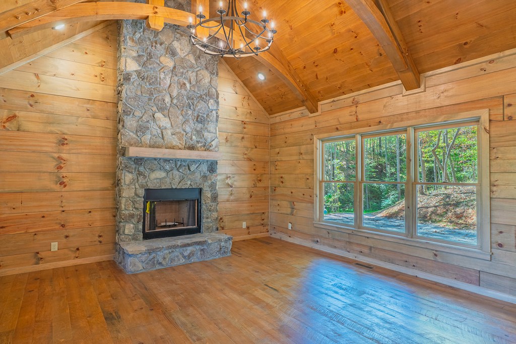 85 Moreland Trail Blue Ridge, GA 30513 - Photo 5 of 56 a view of empty room with wooden floor and fireplace