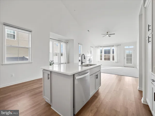 a kitchen with stainless steel appliances granite countertop a sink stove and wooden floor