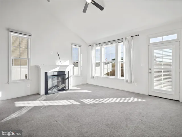 a view of livingroom with fireplace cabinet and windows