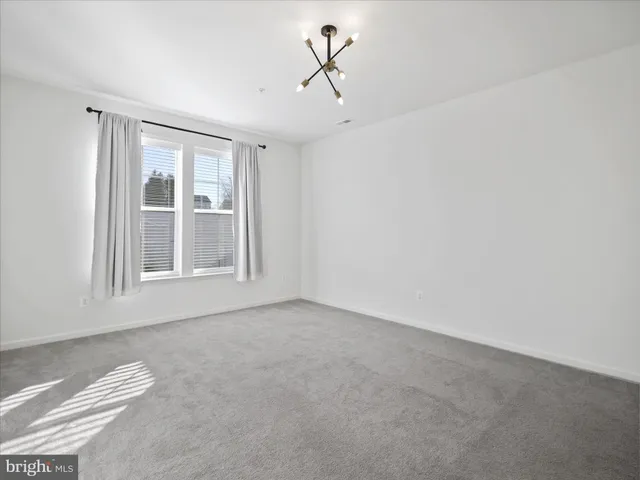 a view of a livingroom with a ceiling fan and window