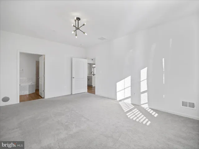 a view of empty room with ceiling fan