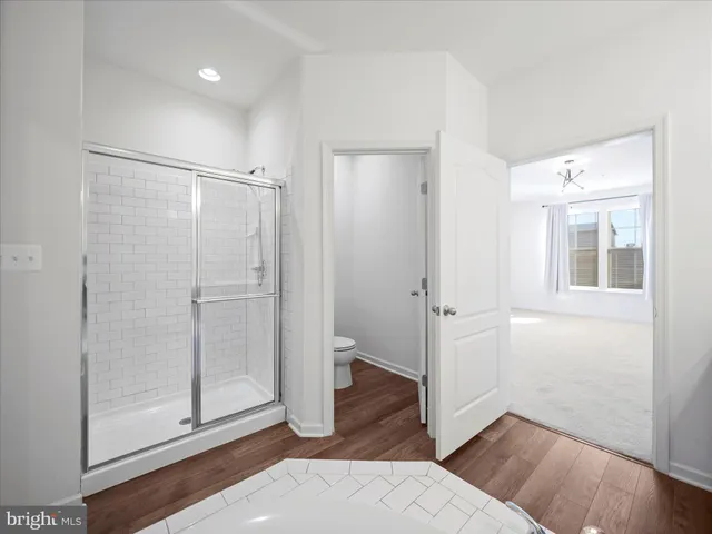 a view of a bathroom with wooden floor