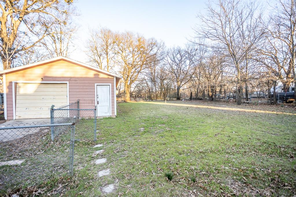 1414 Rice Avenue Gainesville, TX 76240 - Photo 18 of 21 a view of a house with a yard