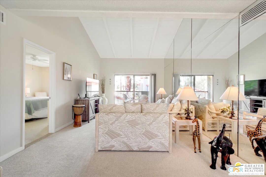 1421 North Sunrise Way, Unit 34 Palm Springs, CA 92262 - Photo 1 of 34 a living room with furniture and a large window