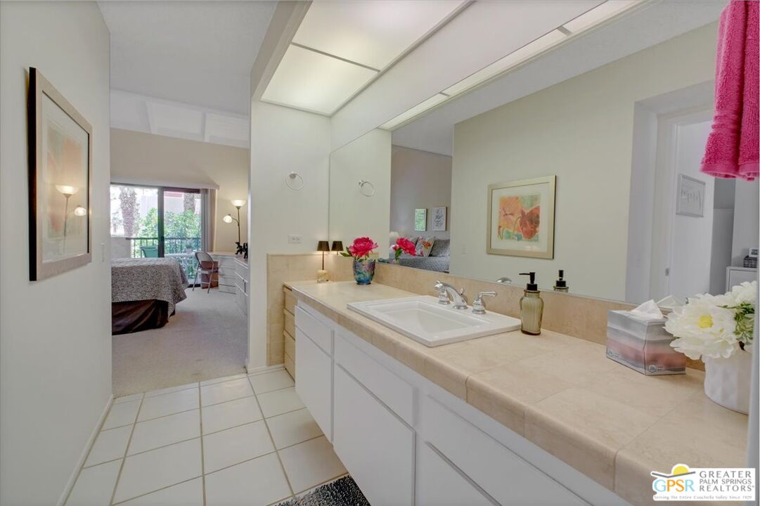 1421 North Sunrise Way, Unit 34 Palm Springs, CA 92262 - Photo 20 of 34 a en suite bathroom with a granite countertop tub and a mirror