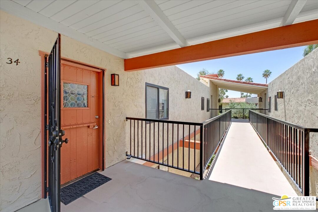 1421 North Sunrise Way, Unit 34 Palm Springs, CA 92262 - Photo 2 of 34 a view of a hallway with window and stairs