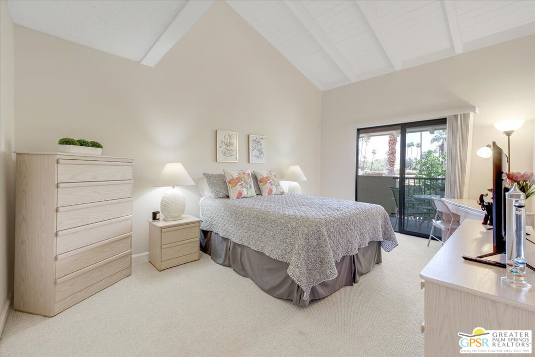1421 North Sunrise Way, Unit 34 Palm Springs, CA 92262 - Photo 22 of 34 a bedroom with bed and large windows