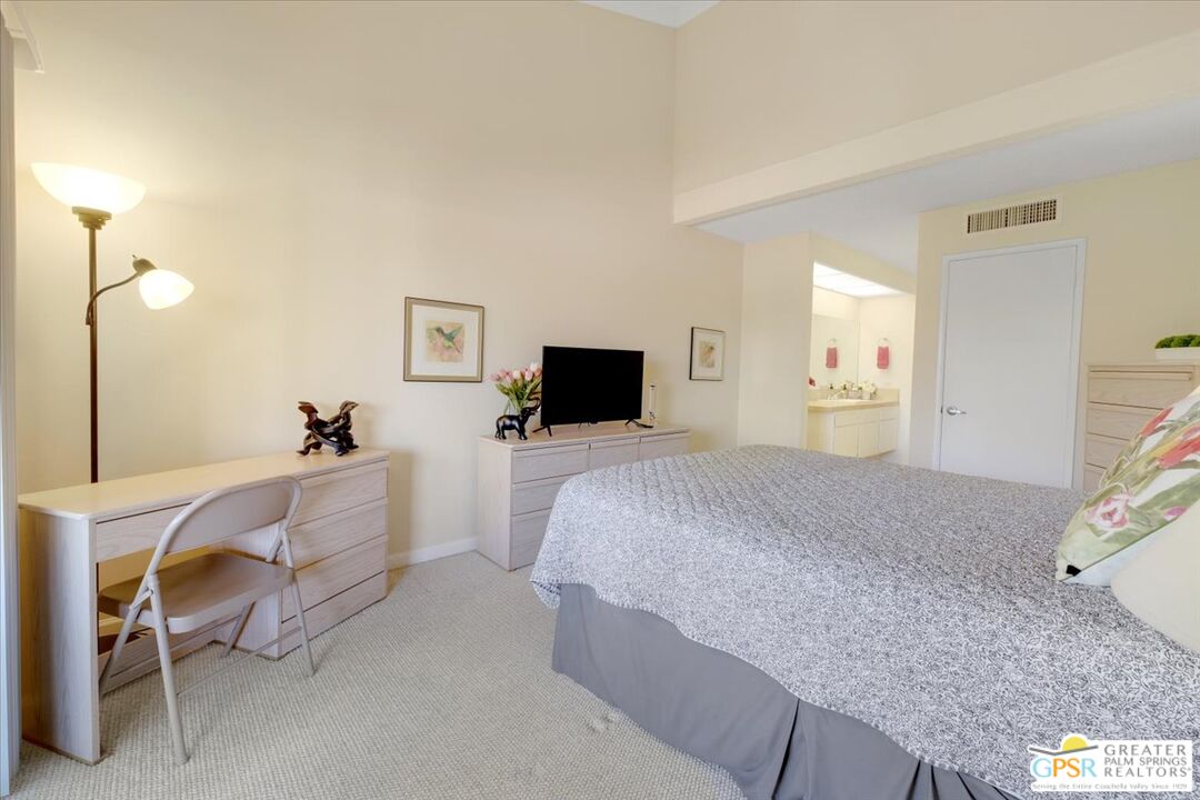 1421 North Sunrise Way, Unit 34 Palm Springs, CA 92262 - Photo 23 of 34 a bed room with a bed and a television