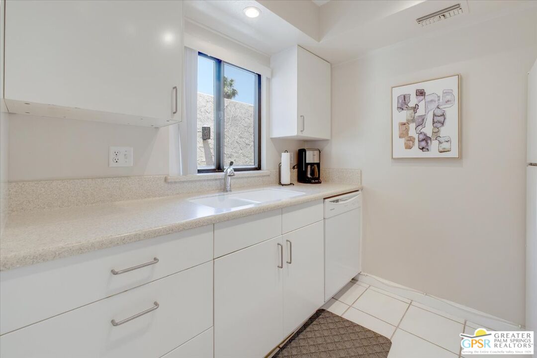 1421 North Sunrise Way, Unit 34 Palm Springs, CA 92262 - Photo 7 of 34 a bathroom with a sink and a mirror