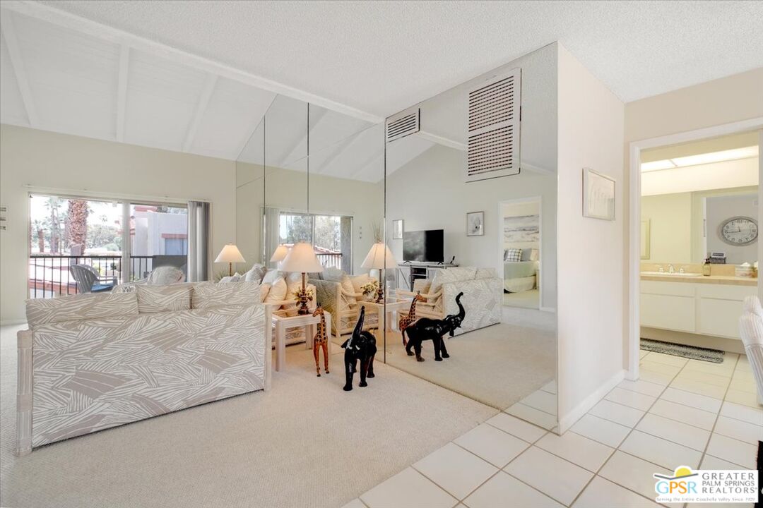 1421 North Sunrise Way, Unit 34 Palm Springs, CA 92262 - Photo 10 of 34 a living room with furniture and a flat screen tv