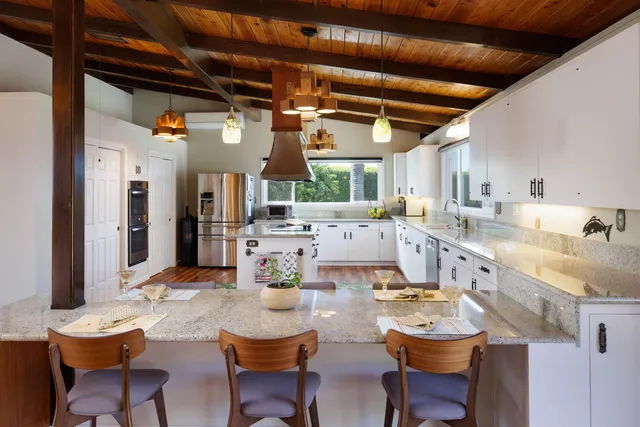 a large kitchen with a table and chairs