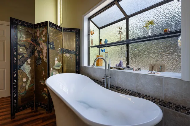 a bathroom with a bathtub and a shower