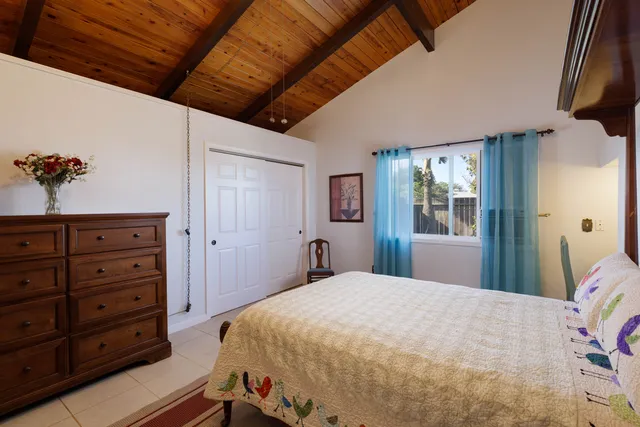 a bedroom with a large bed and a dresser