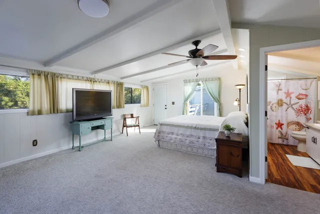 a bedroom with furniture and a flat screen tv