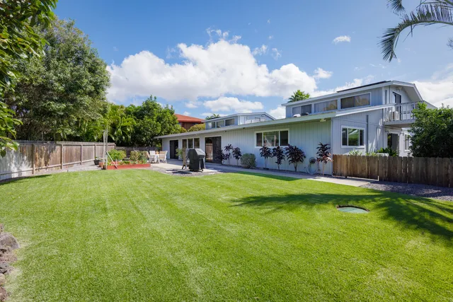 a view of a house with a yard patio and swimming pool