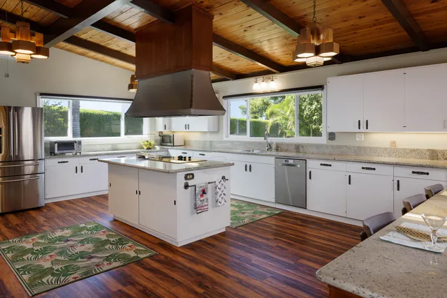 a kitchen with a stove window and cabinets