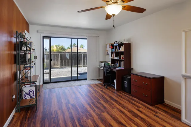 a living room with hard wood floors and a window
