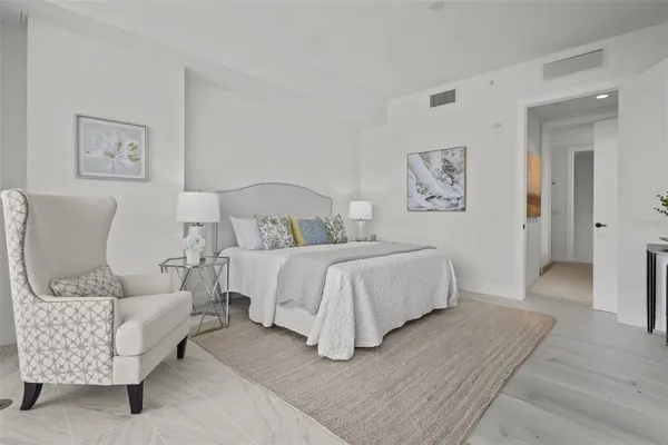 a spacious bedroom with a bed and a couch