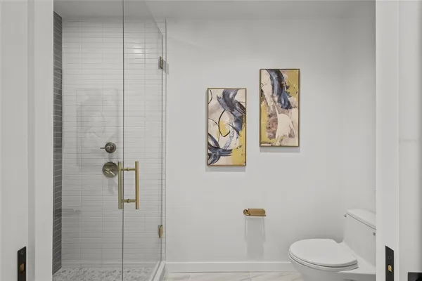 a white toilet sitting next to a bathroom sink