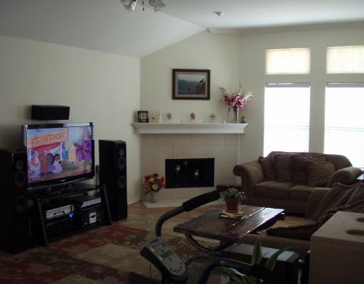 16126 Cuttysark Street Corpus Christi, TX 78418 - Photo 2 of 3 a living room with furniture a flat screen tv and a fireplace