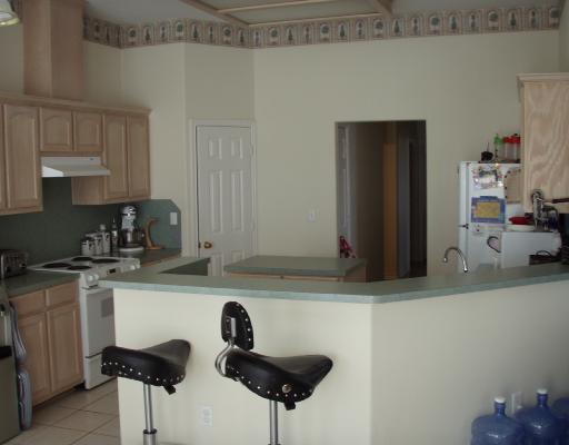 16126 Cuttysark Street Corpus Christi, TX 78418 - Photo 3 of 3 a kitchen with stainless steel appliances a sink a stove and a refrigerator with wooden floor