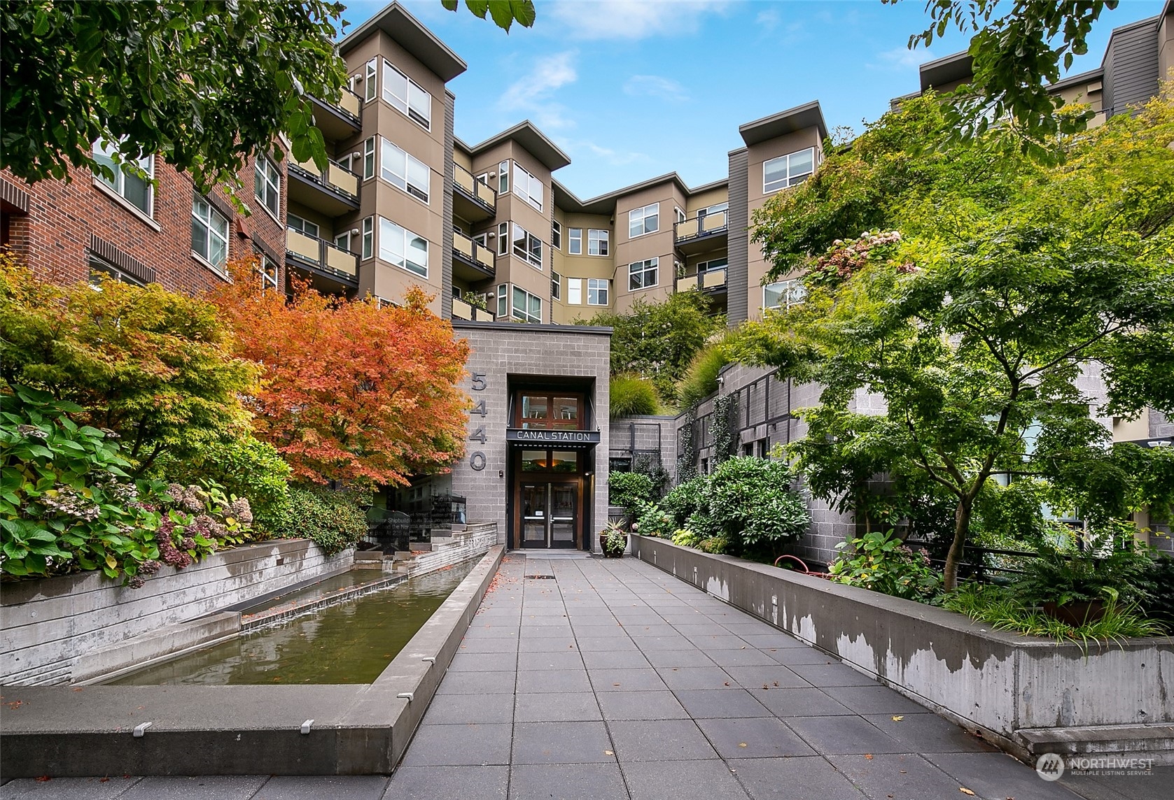 5440 Leary Avenue Northwest, Unit 417 Seattle, WA 98107 - Photo 1 of 21 a view of a house with a yard and pathway