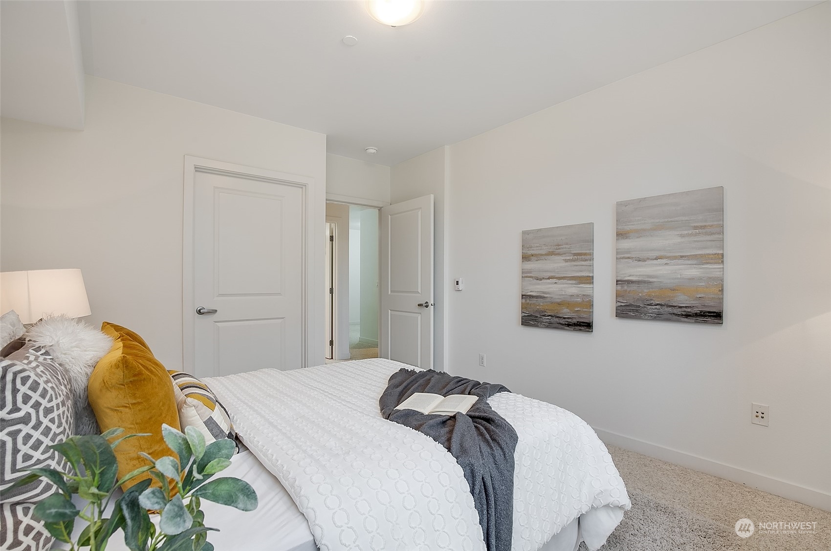 5440 Leary Avenue Northwest, Unit 417 Seattle, WA 98107 - Photo 11 of 21 a bedroom with a bed and a painting on the wall