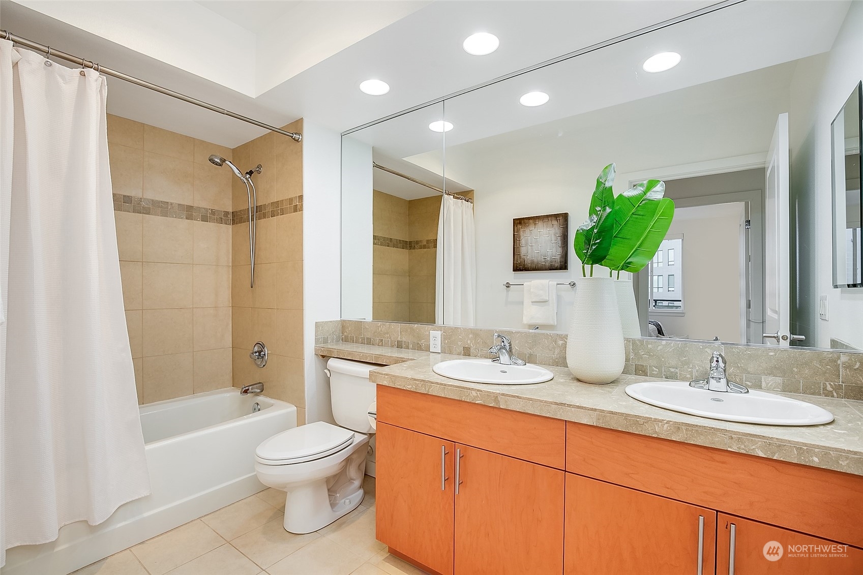 5440 Leary Avenue Northwest, Unit 417 Seattle, WA 98107 - Photo 14 of 21 a bathroom with a double vanity sink toilet and shower