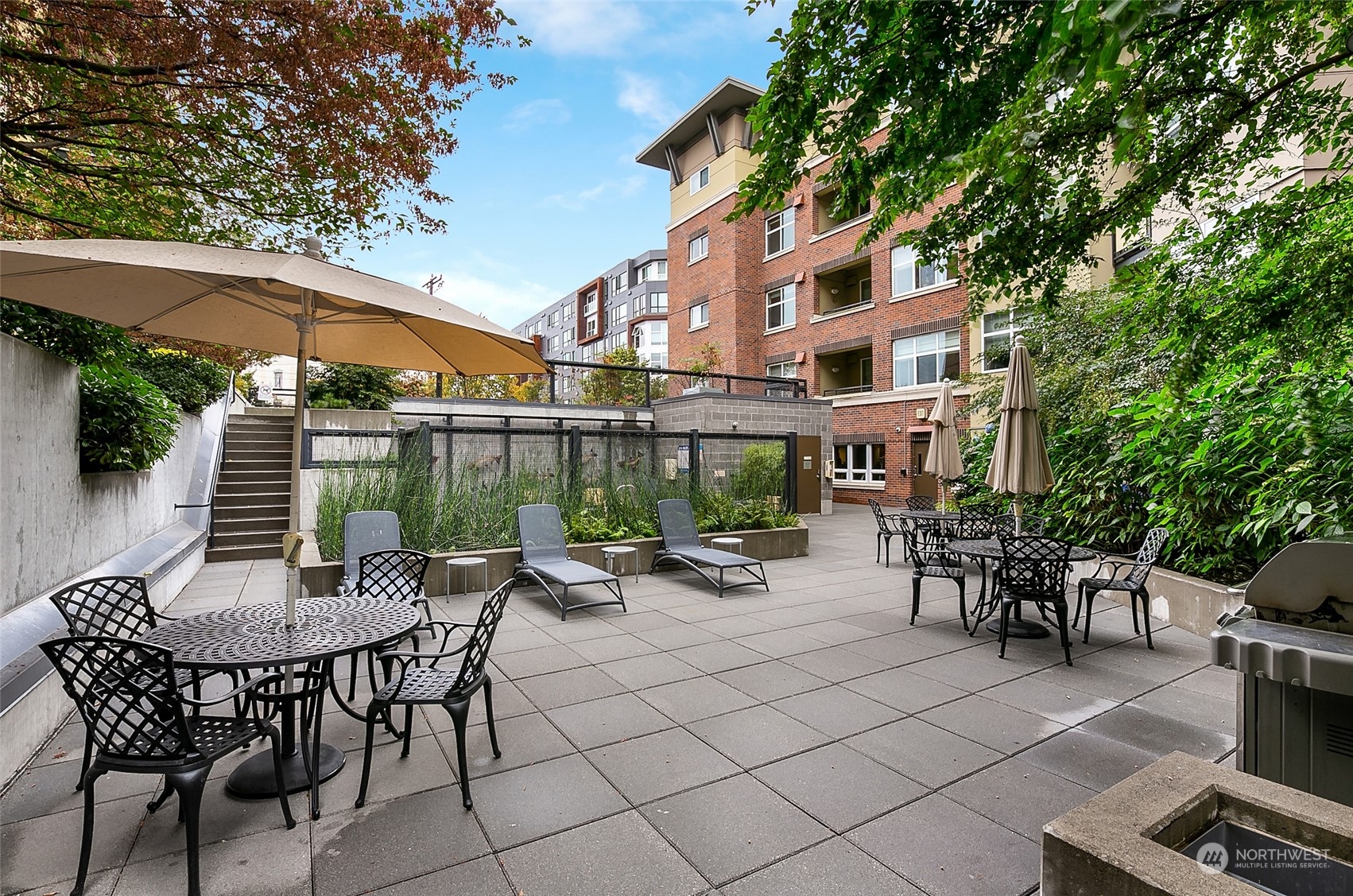 5440 Leary Avenue Northwest, Unit 417 Seattle, WA 98107 - Photo 20 of 21 a view of a patio with a table and chairs under an umbrella
