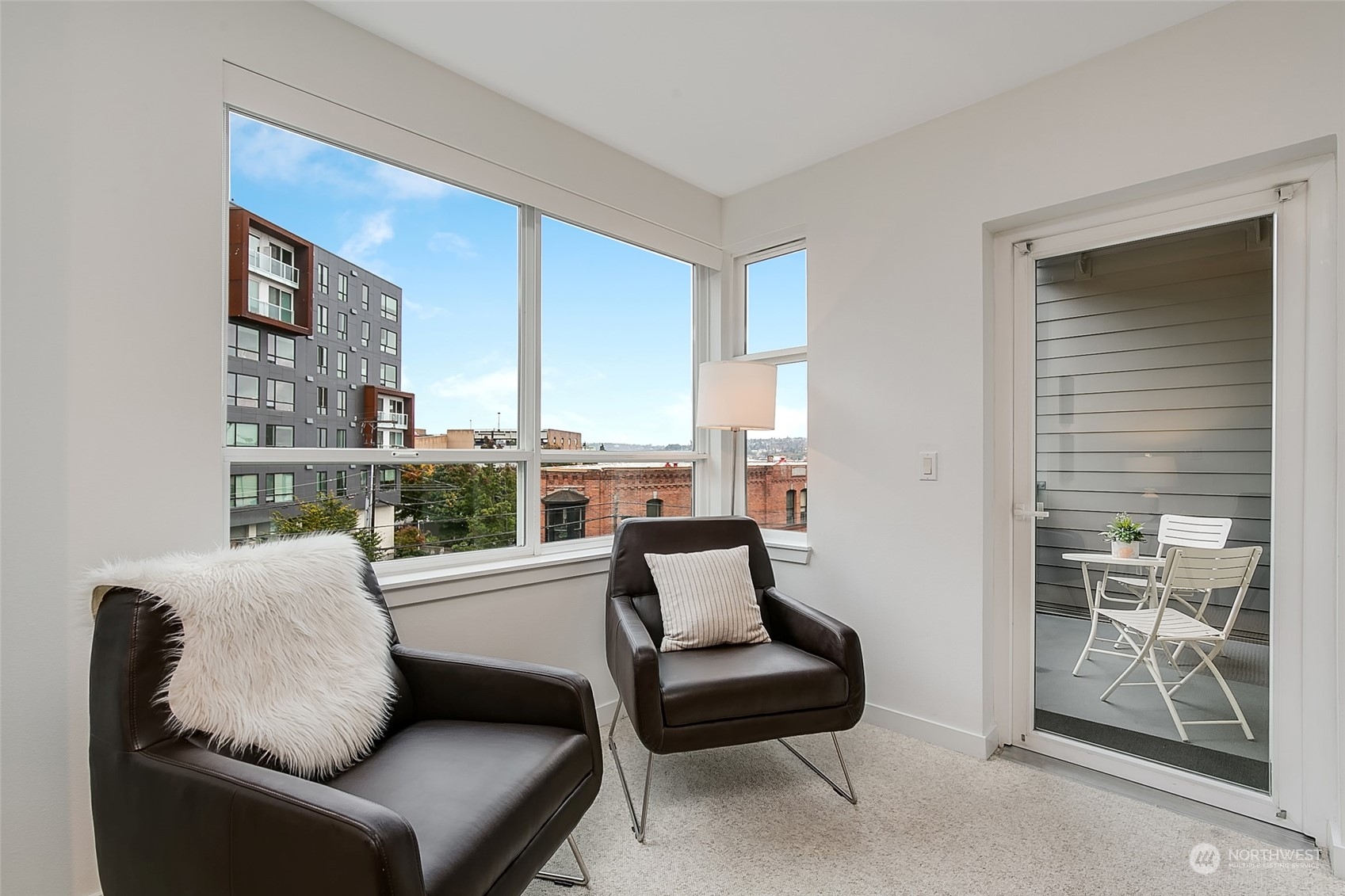 5440 Leary Avenue Northwest, Unit 417 Seattle, WA 98107 - Photo 3 of 21 a living room with furniture and a floor to ceiling window