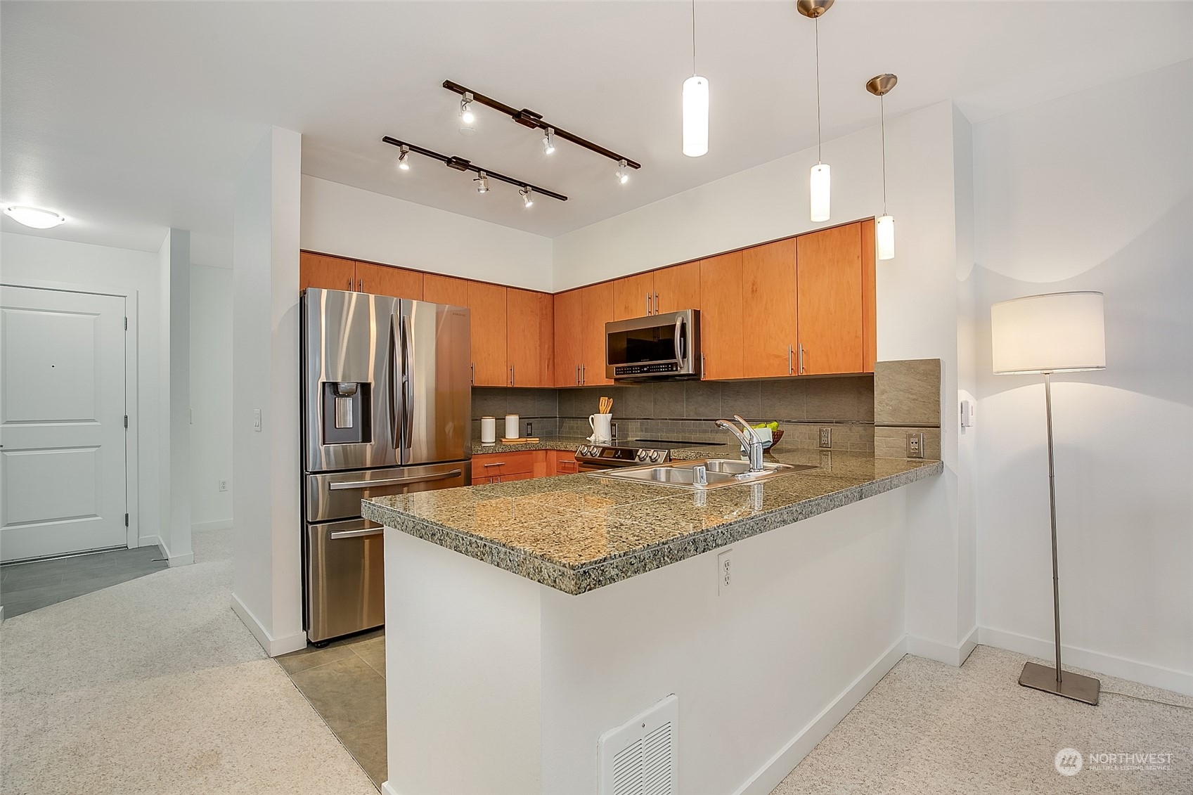 5440 Leary Avenue Northwest, Unit 417 Seattle, WA 98107 - Photo 9 of 21 a kitchen with a refrigerator a sink and a stove