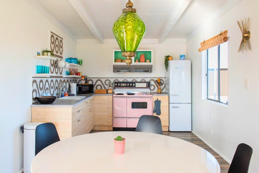 1195 Canyon Road Twentynine Palms, CA 92277 - Photo 8 of 25 a kitchen with a stove a refrigerator and a dining table