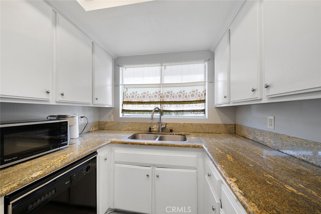 871 West 13th Street, Unit 4 Azusa, CA 91702 - Photo 11 of 22 a kitchen with granite countertop white cabinets white stainless steel appliances and a window