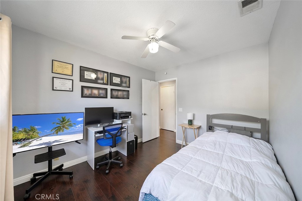 871 West 13th Street, Unit 4 Azusa, CA 91702 - Photo 13 of 22 a bedroom with a bed and a desk