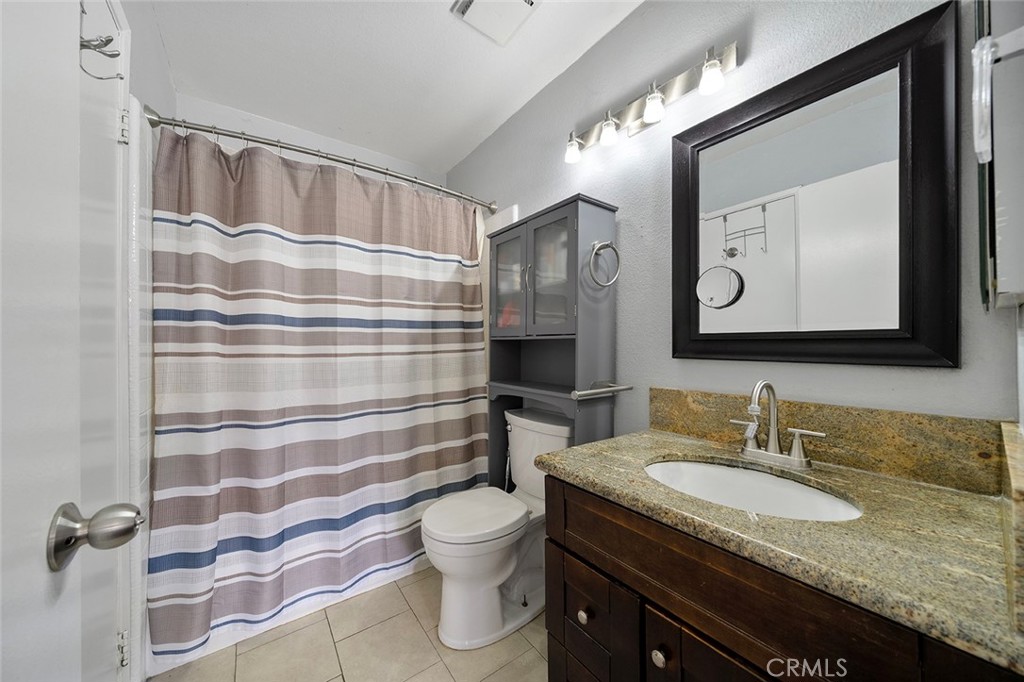 871 West 13th Street, Unit 4 Azusa, CA 91702 - Photo 14 of 22 a bathroom with a granite countertop sink and a mirror