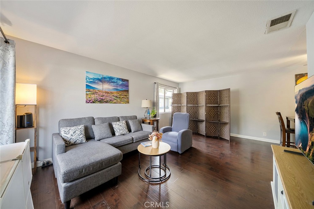871 West 13th Street, Unit 4 Azusa, CA 91702 - Photo 4 of 22 a living room with furniture a rug and kitchen view
