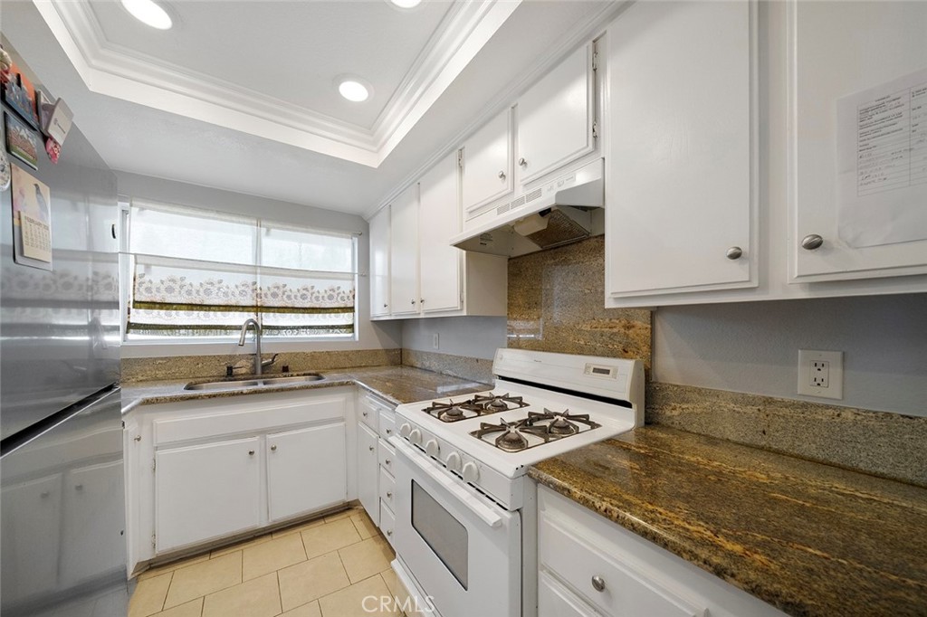 871 West 13th Street, Unit 4 Azusa, CA 91702 - Photo 10 of 22 a kitchen with white cabinets sink and appliances