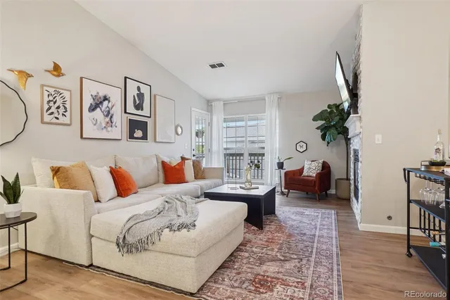 a living room with furniture and a potted plant